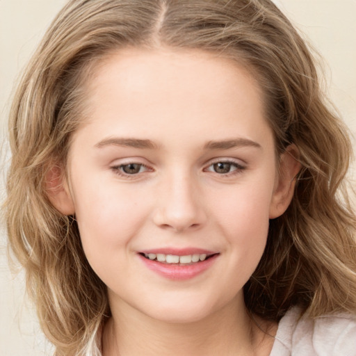 Joyful white child female with long  brown hair and grey eyes