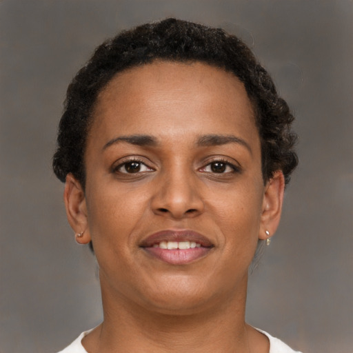 Joyful black young-adult female with short  brown hair and brown eyes