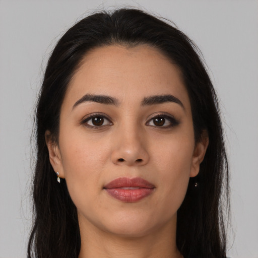 Joyful latino young-adult female with long  brown hair and brown eyes