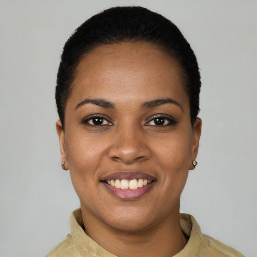 Joyful black young-adult female with short  black hair and brown eyes