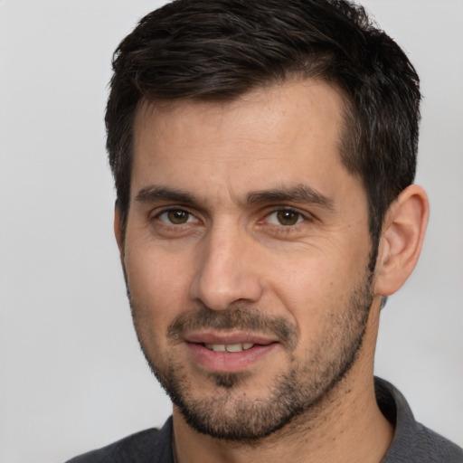 Joyful white adult male with short  brown hair and brown eyes