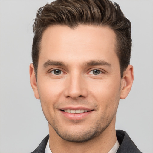 Joyful white young-adult male with short  brown hair and brown eyes