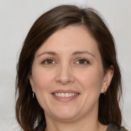 Joyful white adult female with medium  brown hair and brown eyes