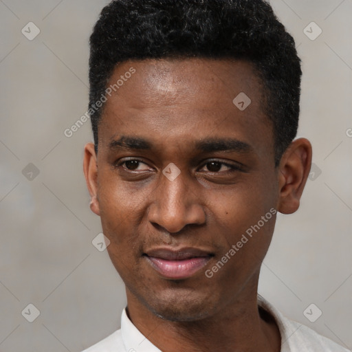 Joyful black young-adult male with short  black hair and brown eyes