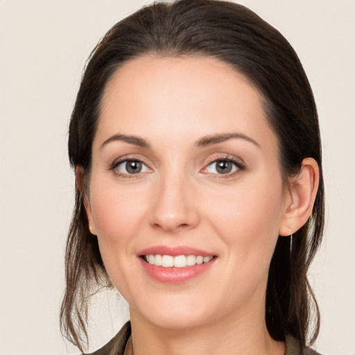 Joyful white young-adult female with medium  brown hair and brown eyes