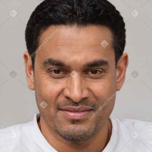 Joyful latino adult male with short  black hair and brown eyes