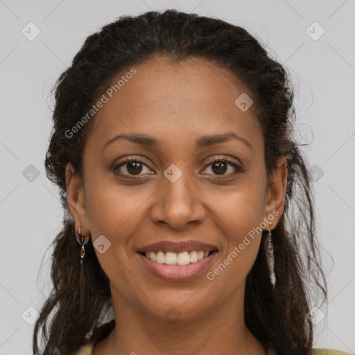 Joyful black young-adult female with long  brown hair and brown eyes