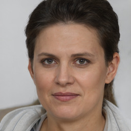 Joyful white adult female with short  brown hair and brown eyes