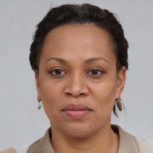 Joyful black adult female with short  brown hair and brown eyes
