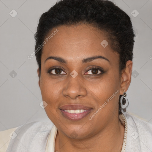 Joyful black young-adult female with short  brown hair and brown eyes