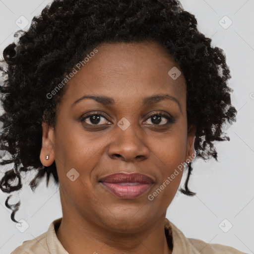 Joyful black adult female with short  brown hair and brown eyes