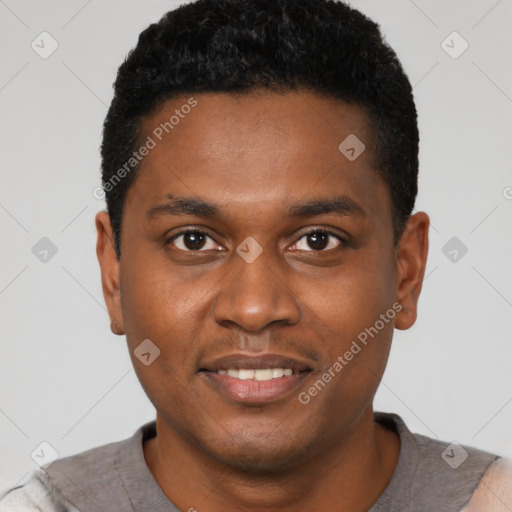 Joyful black young-adult male with short  black hair and brown eyes