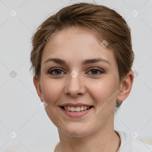 Joyful white young-adult female with short  brown hair and grey eyes