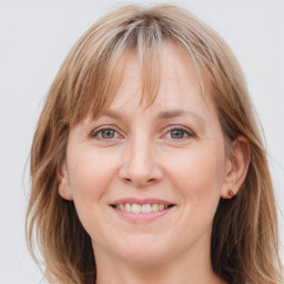 Joyful white adult female with long  brown hair and grey eyes