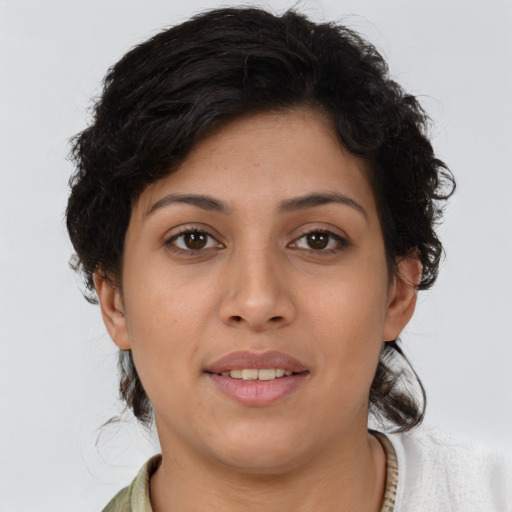 Joyful latino young-adult female with short  brown hair and brown eyes