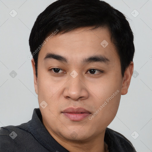 Joyful asian young-adult male with short  black hair and brown eyes