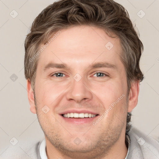 Joyful white adult male with short  brown hair and grey eyes