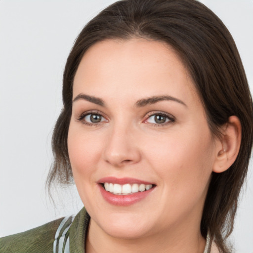 Joyful white young-adult female with medium  brown hair and brown eyes