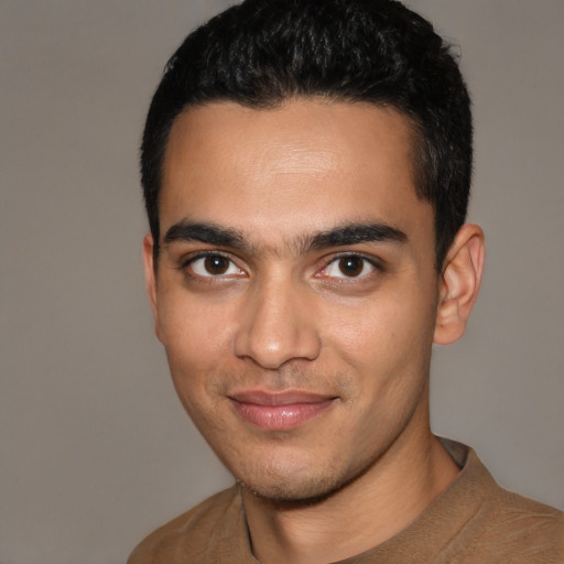 Joyful latino young-adult male with short  black hair and brown eyes