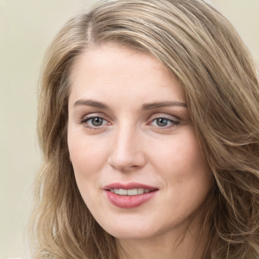 Joyful white young-adult female with long  brown hair and green eyes