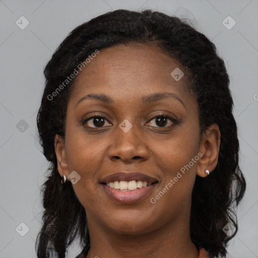 Joyful black young-adult female with long  brown hair and brown eyes