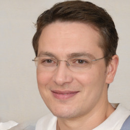 Joyful white adult male with short  brown hair and brown eyes