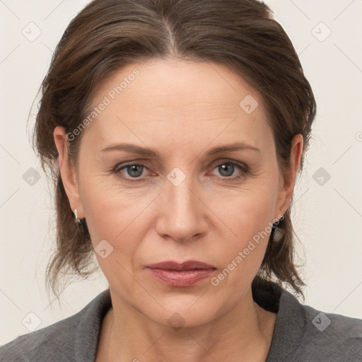 Joyful white adult female with medium  brown hair and grey eyes