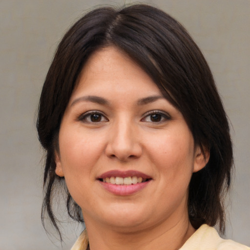 Joyful asian adult female with medium  brown hair and brown eyes