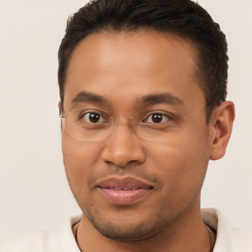 Joyful black adult male with short  brown hair and brown eyes