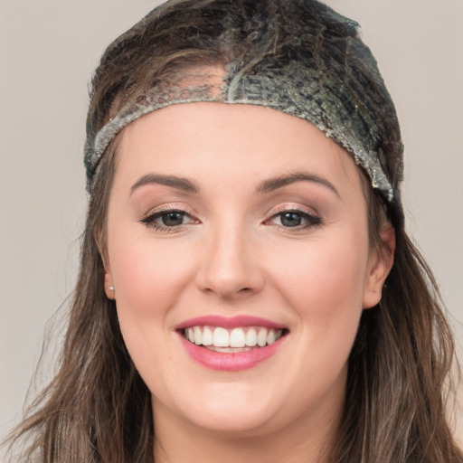 Joyful white young-adult female with long  brown hair and grey eyes