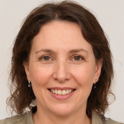 Joyful white adult female with medium  brown hair and grey eyes