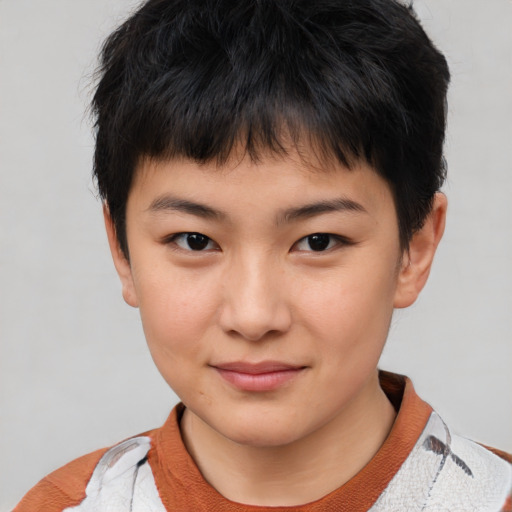 Joyful asian child male with short  brown hair and brown eyes
