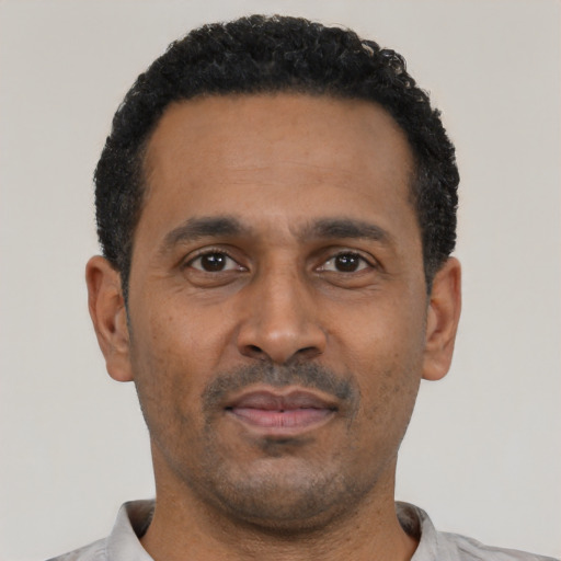 Neutral latino adult male with short  black hair and brown eyes