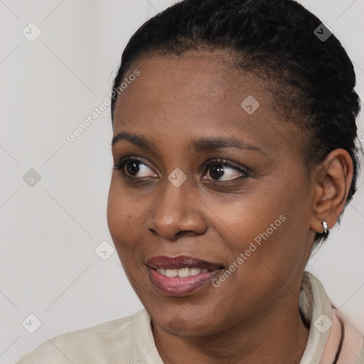 Joyful black young-adult female with short  brown hair and brown eyes