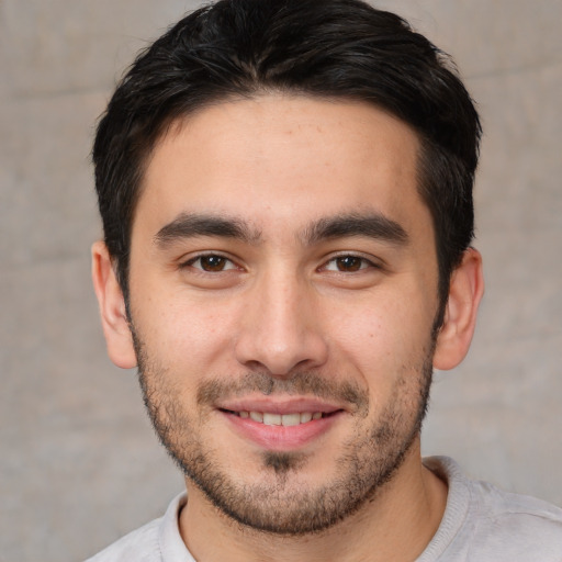 Joyful white young-adult male with short  brown hair and brown eyes