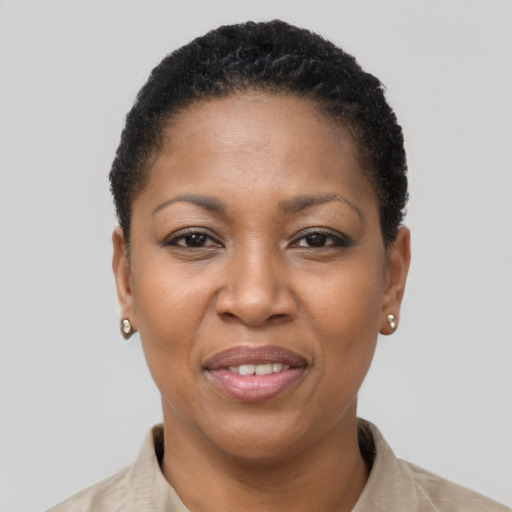 Joyful black young-adult female with short  brown hair and brown eyes