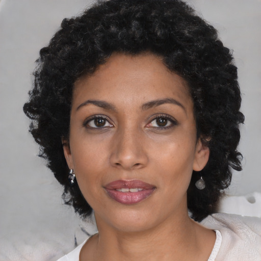 Joyful latino young-adult female with medium  black hair and brown eyes
