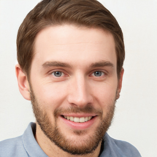 Joyful white young-adult male with short  brown hair and grey eyes