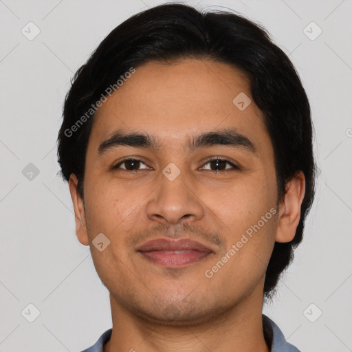 Joyful latino young-adult male with short  black hair and brown eyes