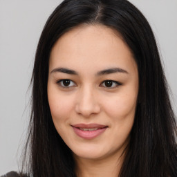 Joyful asian young-adult female with long  brown hair and brown eyes