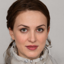 Joyful white young-adult female with medium  brown hair and grey eyes