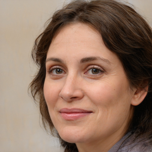 Joyful white adult female with medium  brown hair and brown eyes