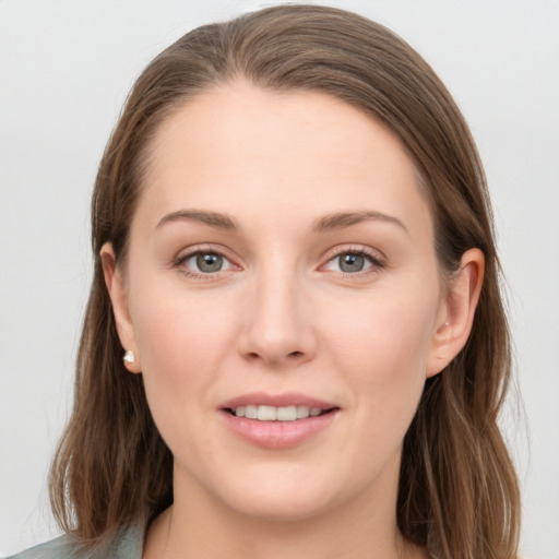 Joyful white young-adult female with long  brown hair and grey eyes