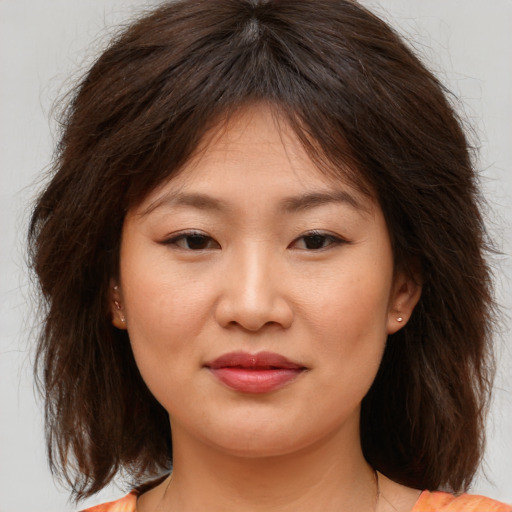 Joyful asian young-adult female with medium  brown hair and brown eyes