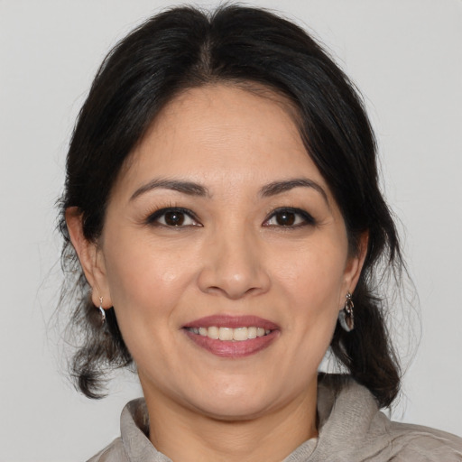 Joyful white adult female with medium  brown hair and brown eyes