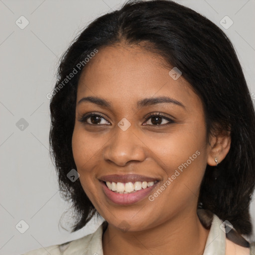 Joyful black young-adult female with medium  brown hair and brown eyes