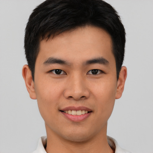 Joyful asian young-adult male with short  brown hair and brown eyes