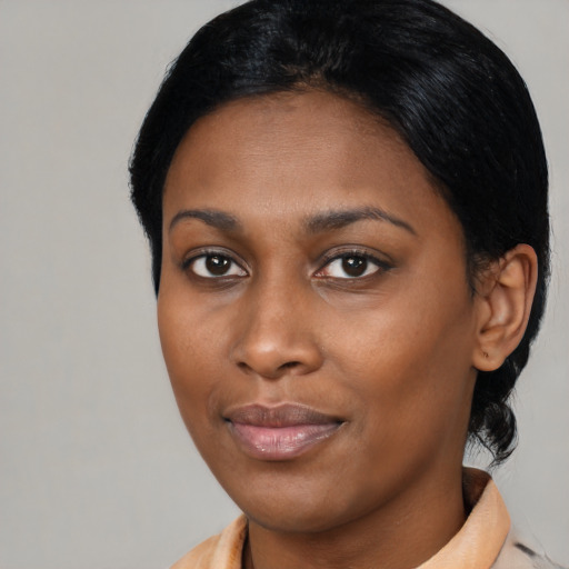 Joyful black young-adult female with short  brown hair and brown eyes