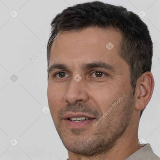 Joyful white adult male with short  brown hair and brown eyes