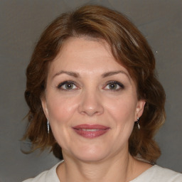 Joyful white adult female with medium  brown hair and brown eyes